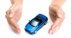 woman hands holding blue car isolated on white background